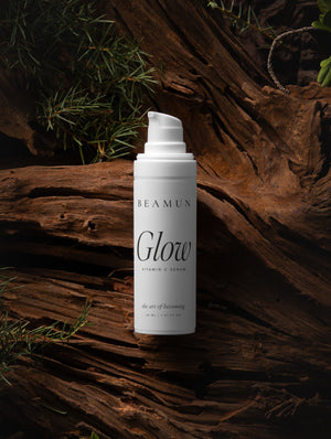 Glow bottle against dark driftwood and pine