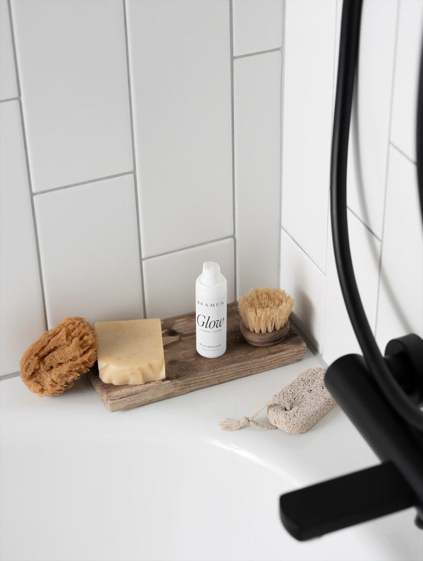 Glow bottle on a bathroom shelf with a brush and soap