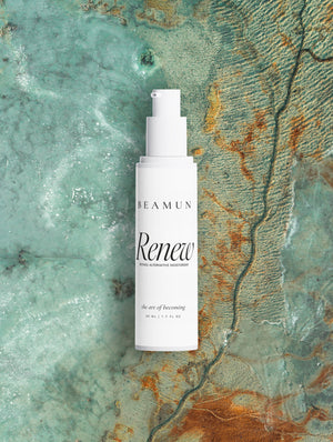 Renew bottle above turquoise water and a rust-coloured shoreline