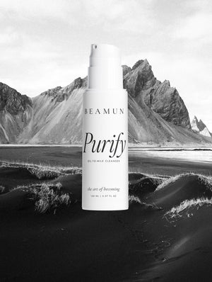 Purify bottle against a black sand beach and mountain