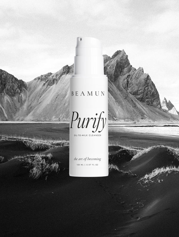 Purify bottle against a black sand beach and mountain
