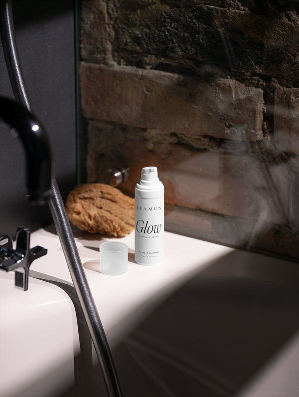 Glow bottle by a basin against a stone wall